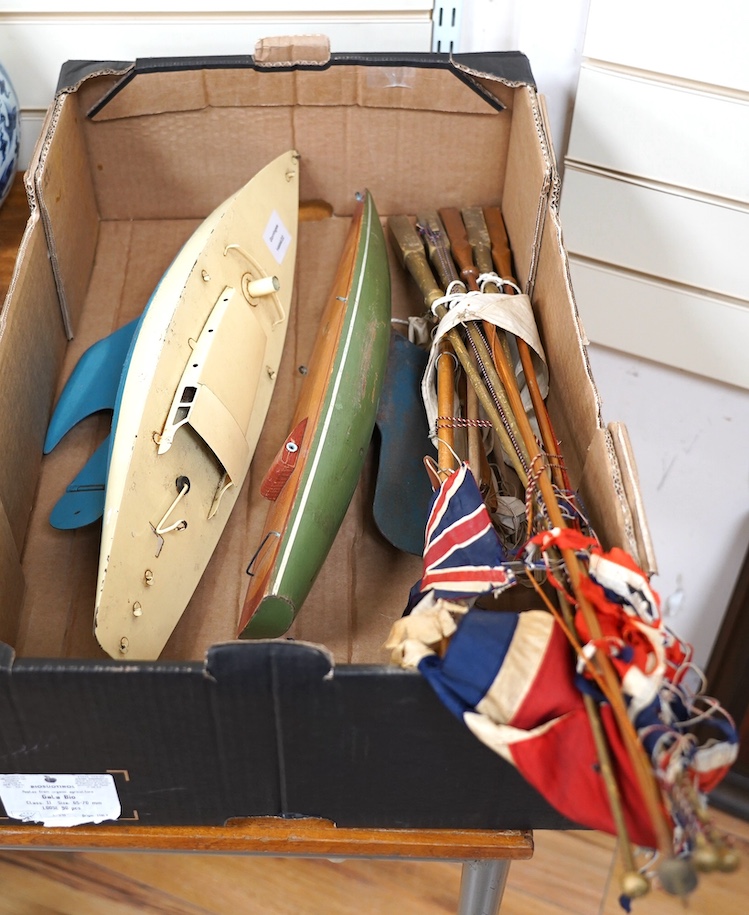 Two Tri-ang pond yachts, one painted tin plate, the other painted wood, together with various masts and flags. Condition - poor to fair